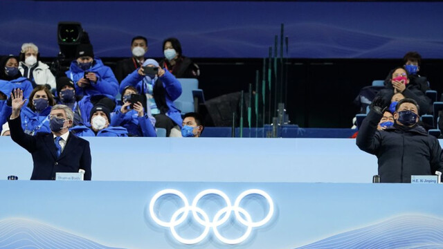 Thomas Bach (L) and Xi Jinping wave during the opening ceremony of 2022 Winter Olympics. Thomas Bach (L) and Xi Jinping wave during the opening ceremony of 2022 Winter Olympics.
