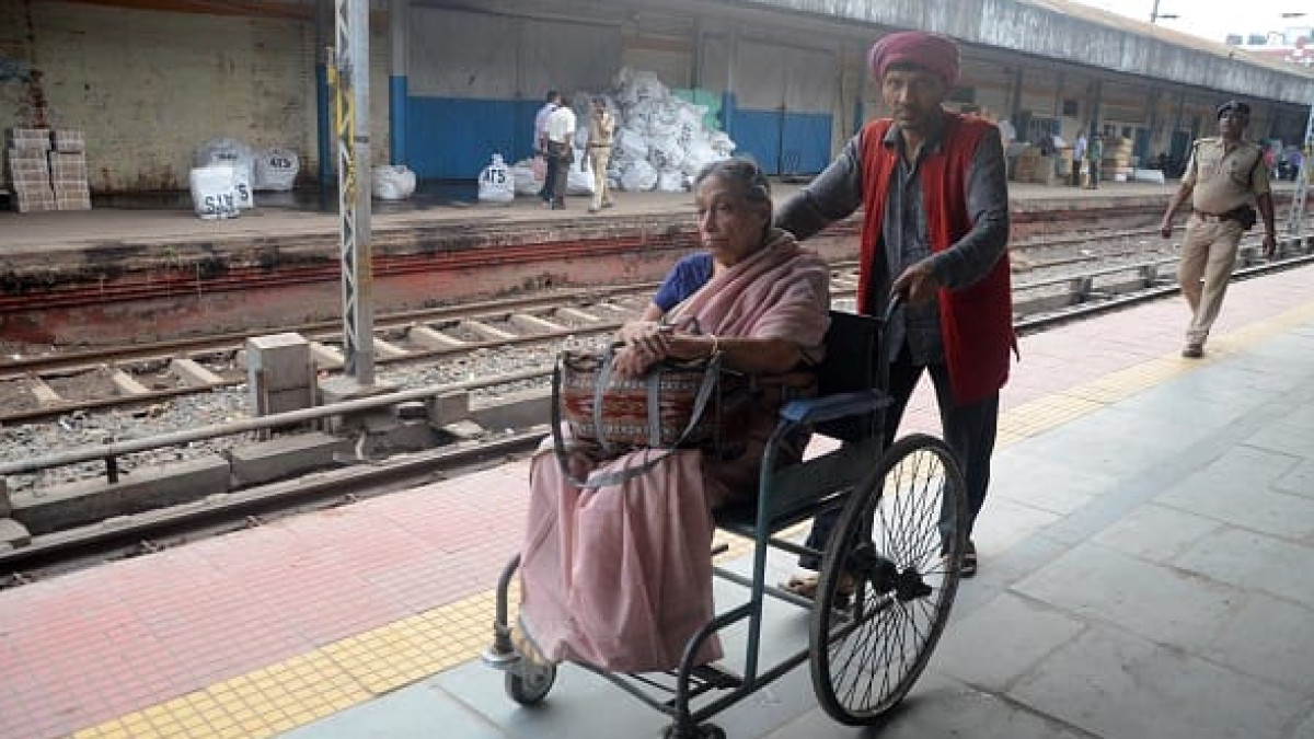 A man pushing a woman on a wheelchair